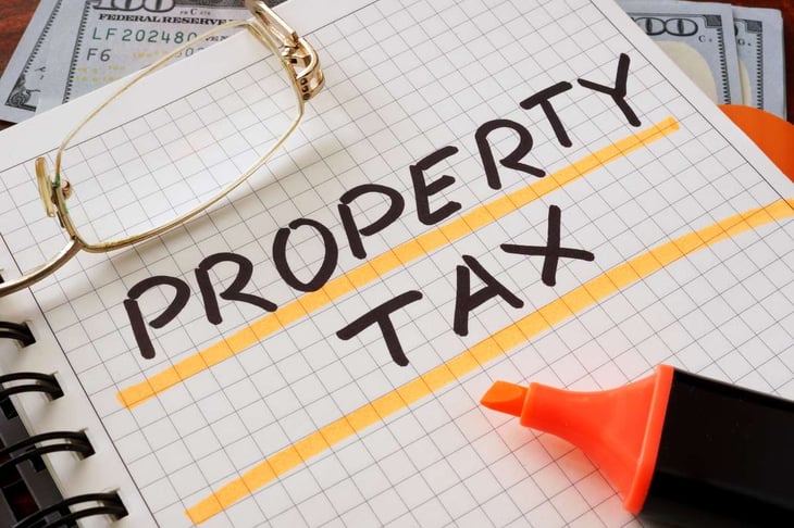 Notebook with property tax sign on a table. Business concept