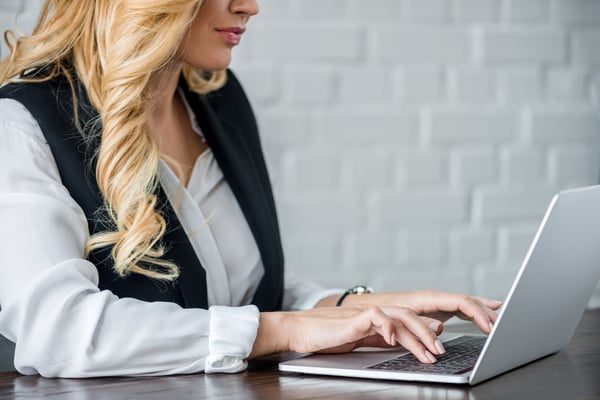 Cropped image of businesswoman using laptop