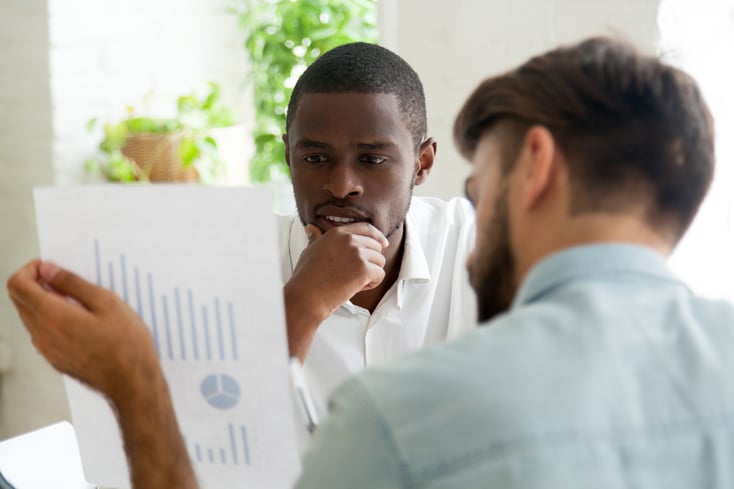 Interested black client listening to financial advisor explaining