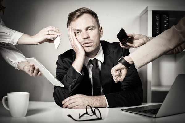 Man overloaded with stuff at work