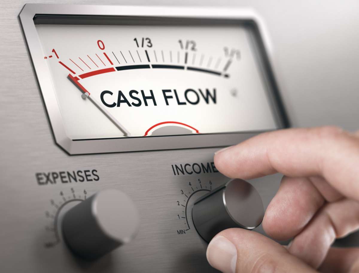 Man turning knob to increase income and cash flow level