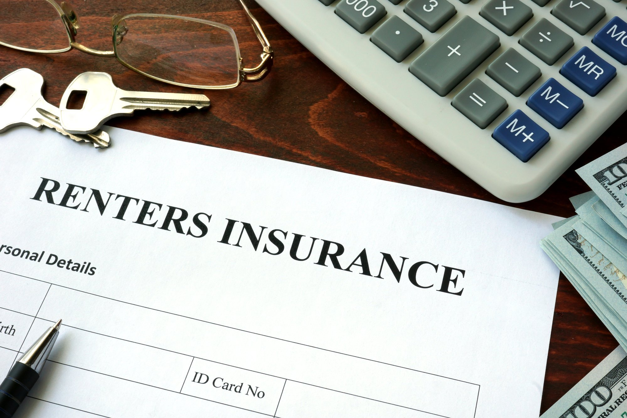 Renters insurance form and dollars on the table