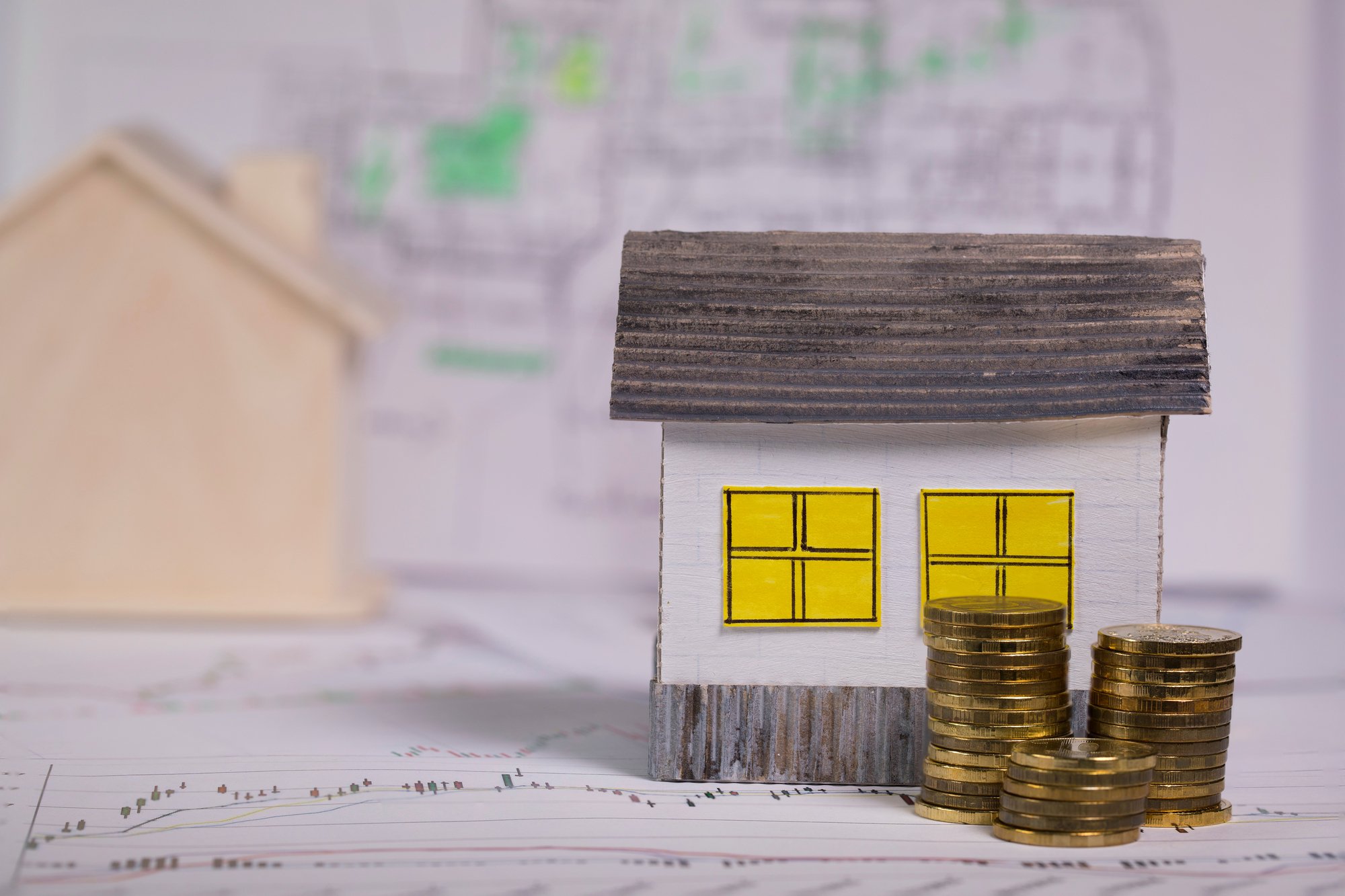 Small paper house on a technical drawing. Closeup