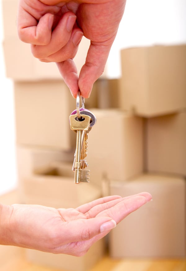 Person handing over the keys of a new house moving concepts