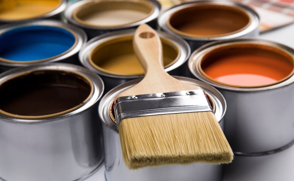 different colored paint cans and paint brush