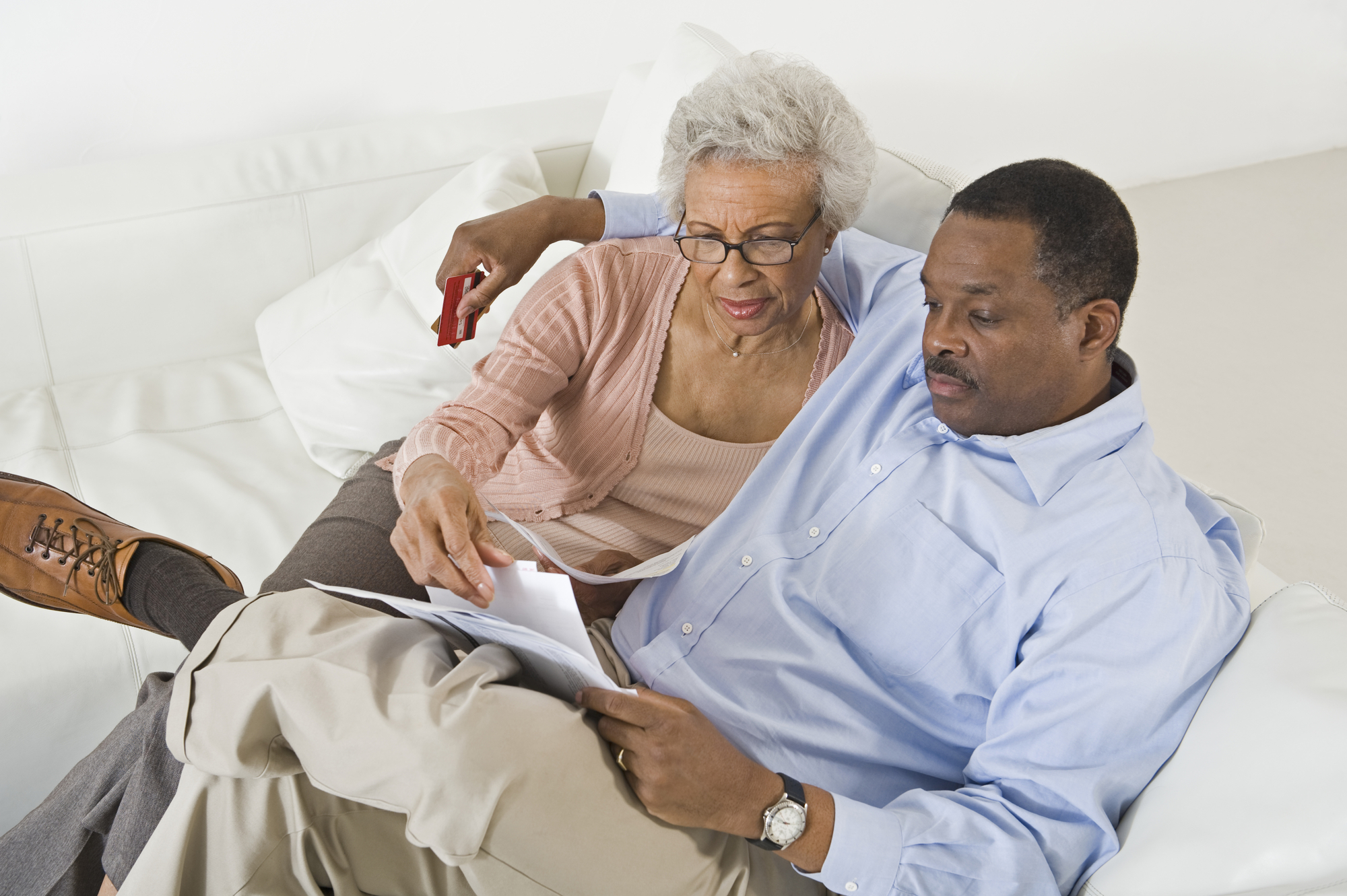 Couple Looking At Bills Worried With Home Finances