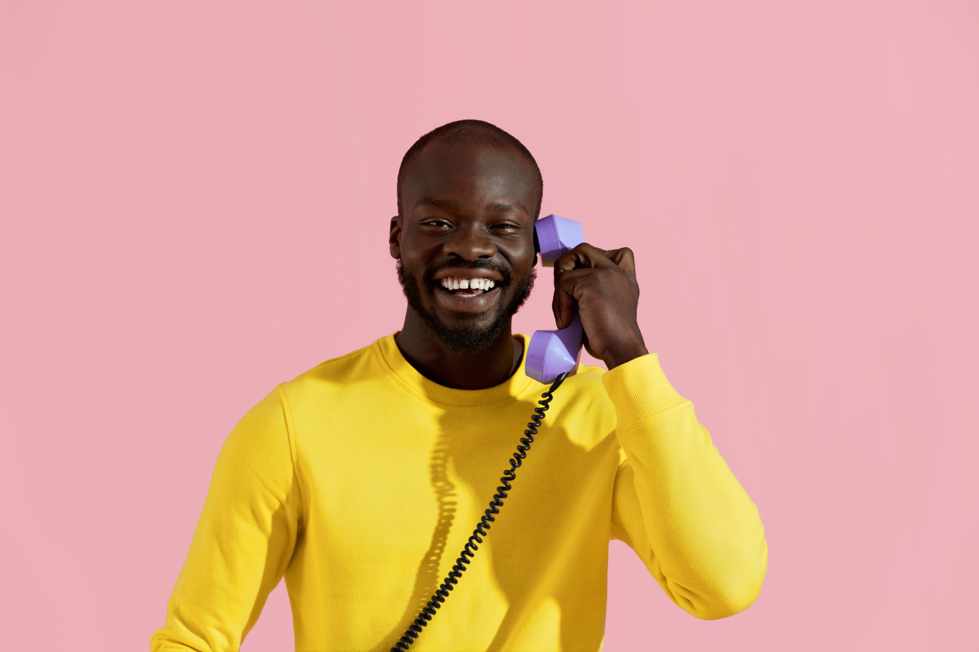 Smiling black man with purple phone colorful portrait